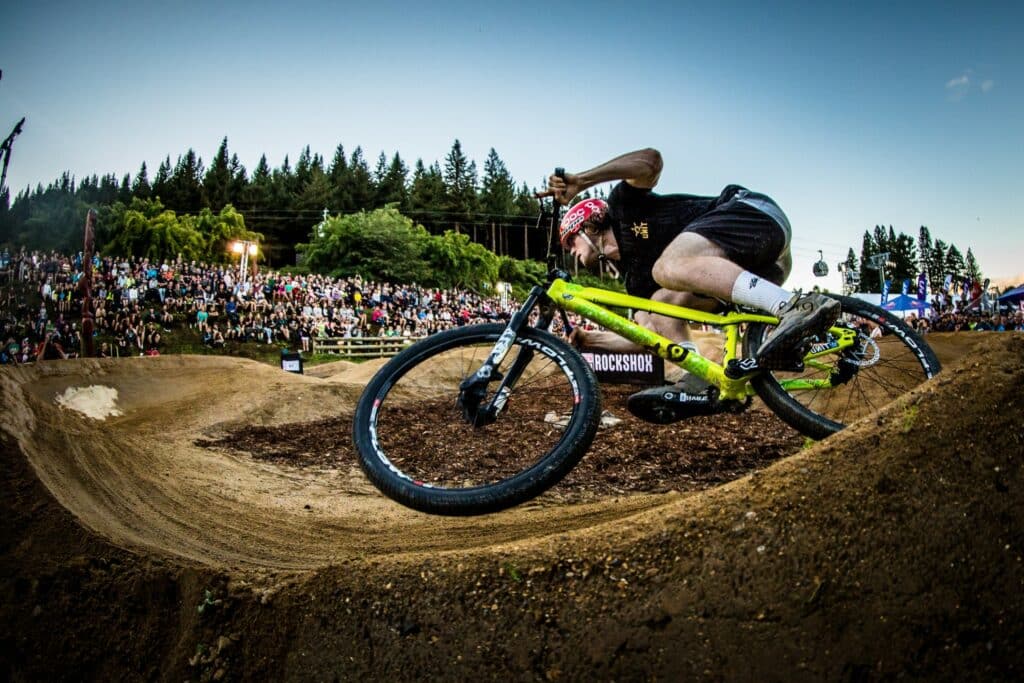 Rider effectuant un virage serré après avoir pumpé sur une série de bosses dans un pumptrack