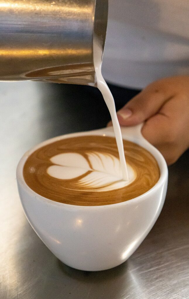 Un barista réalisant un motif délicat sur un café
