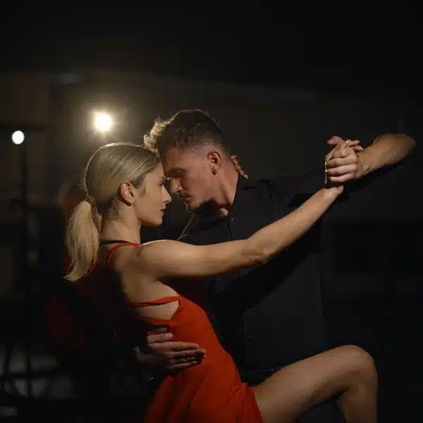 Couple réalisant un pas de swing parfaitement synchronisé, illustrant la connexion entre les danseurs